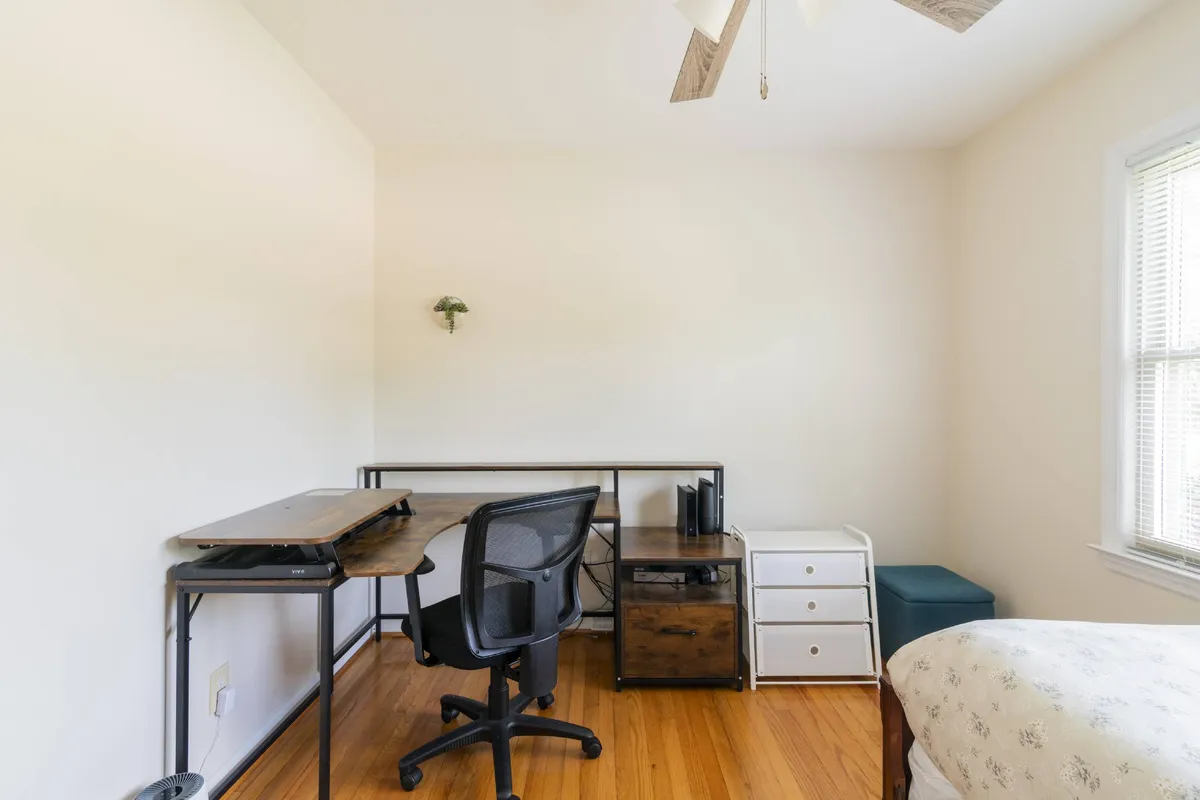 A tranquil bedroom with a comfortable bed, a nightstand, and a dedicated desk and chair. The workspace is thoughtfully arranged for focus and creativity, while the rest of the room exudes a peaceful ambiance for unwinding.